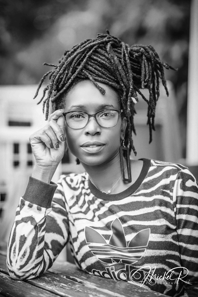 Portrait féminin en noir et blanc, regard à travers des lunettes